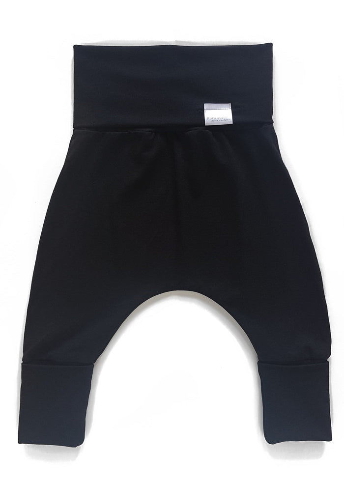 Black grow-with-me pants for toddlers and kids, made from soft, eco-friendly fabric. Adjustable waistband and cuffs for extended wear. Ethically made in Canada.