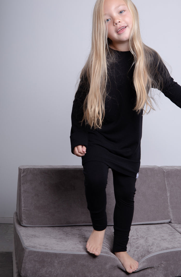 Black grow-with-me pants for toddlers and kids, made from soft, eco-friendly fabric. Adjustable waistband and cuffs for extended wear. Ethically made in Canada.