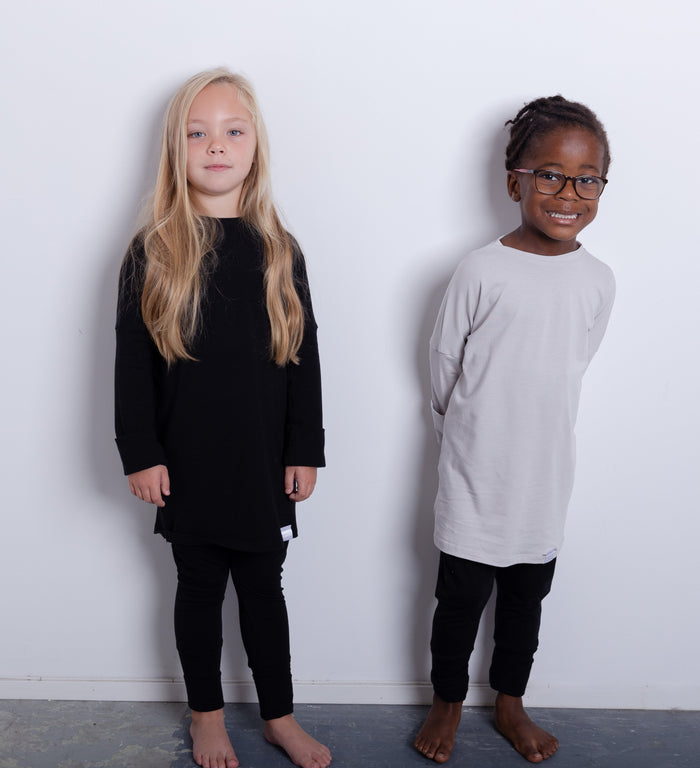Black grow-with-me pants for toddlers and kids, made from soft, eco-friendly fabric. Adjustable waistband and cuffs for extended wear. Ethically made in Canada.