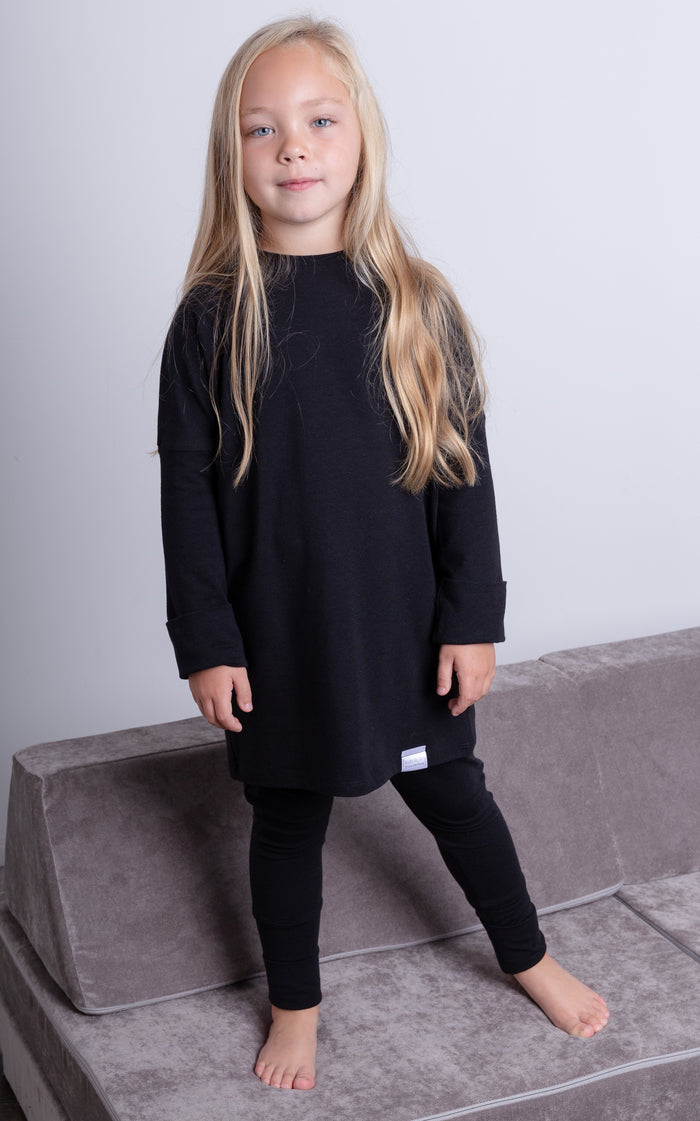 Black grow-with-me pants for toddlers and kids, made from soft, eco-friendly fabric. Adjustable waistband and cuffs for extended wear. Ethically made in Canada.