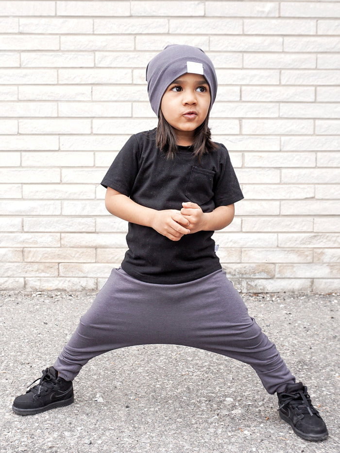 Dark Grey grow-with-me pants for toddlers and kids, made from soft, eco-friendly fabric. Adjustable waistband and cuffs for extended wear. Ethically made in Canada.