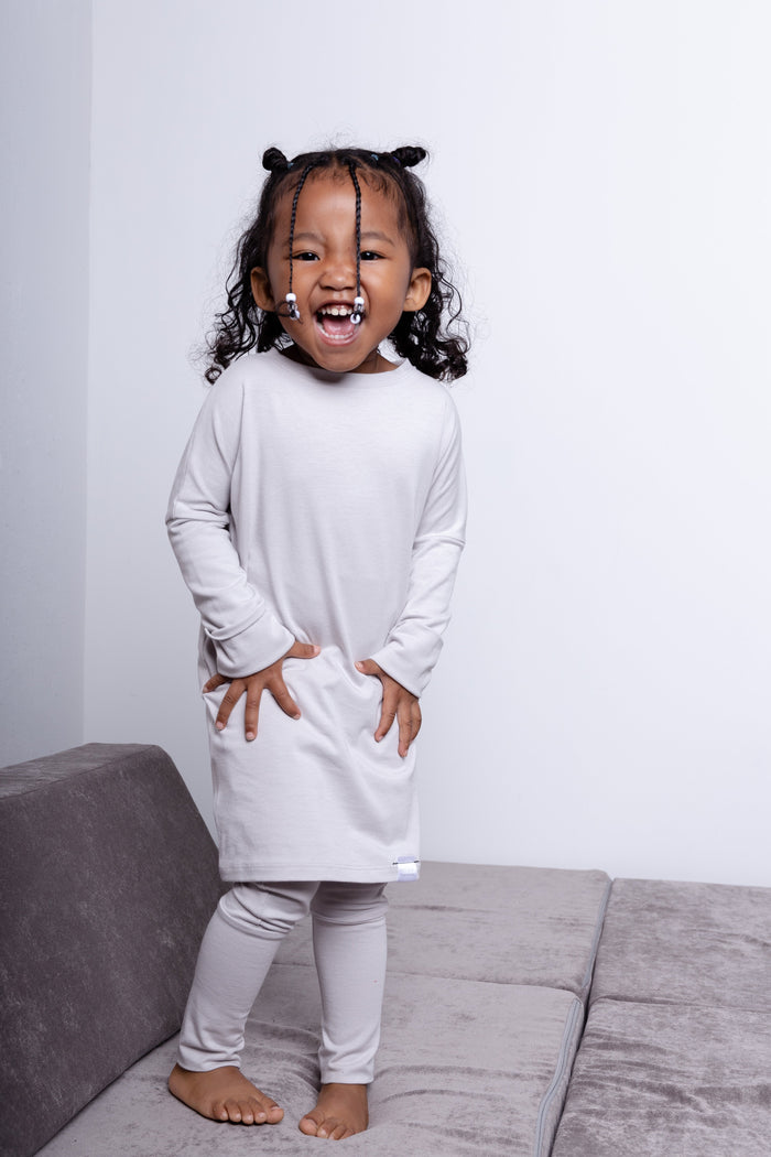Taupe grow-with-me pants for toddlers and kids, made from soft, eco-friendly fabric. Adjustable waistband and cuffs for extended wear. Ethically made in Canada.