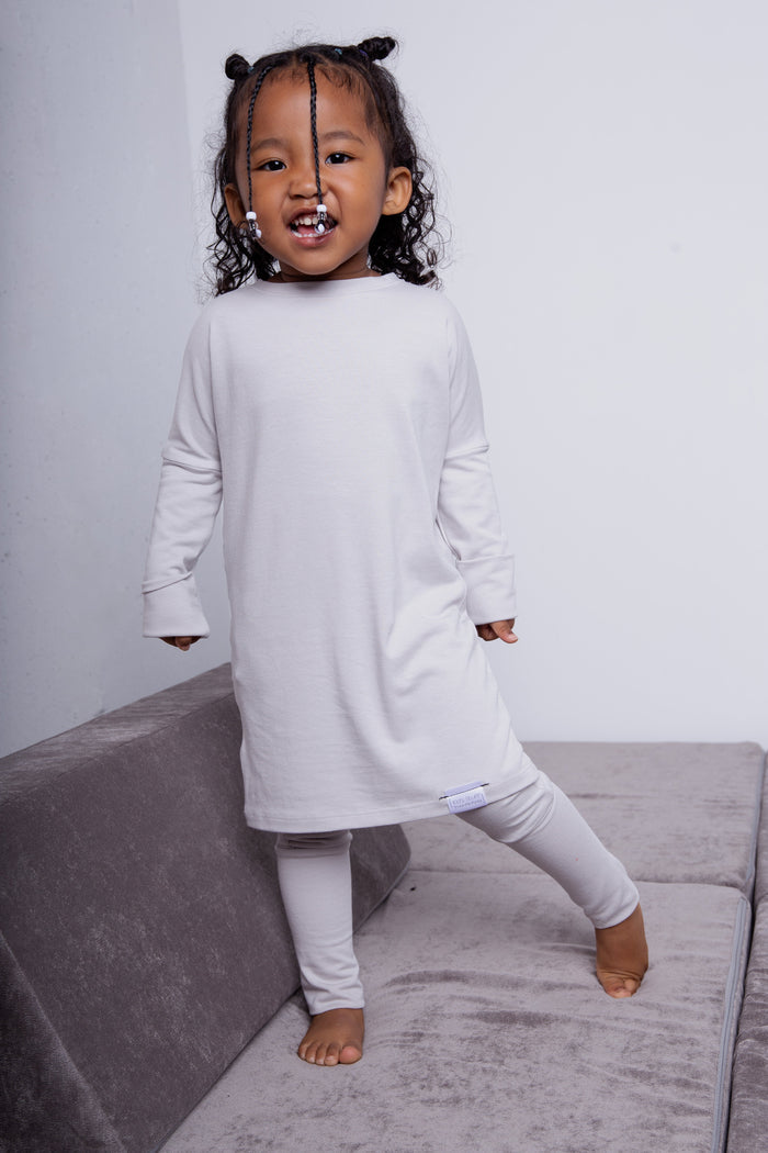 Taupe grow-with-me pants for toddlers and kids, made from soft, eco-friendly fabric. Adjustable waistband and cuffs for extended wear. Ethically made in Canada.
