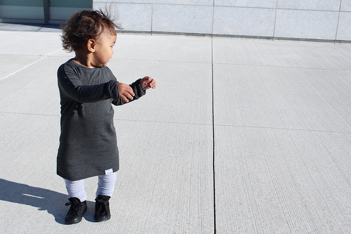 Dark Grey grow-with-me shirt for toddlers and kids, designed to be worn as a dress, tunic, or long shirt. Seamless shoulders and soft, eco-friendly fabric. Ethically made in Canada.