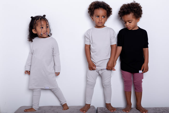 Black grow-with-me t-shirt for kids, made from soft Lyocell. Ethically made in Canada for a sustainable and comfy fit.