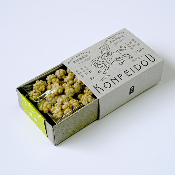 A box of Konpeidou confectionery sweets, partially opened to reveal the golden-brown confection pieces inside, set against a clean white background.