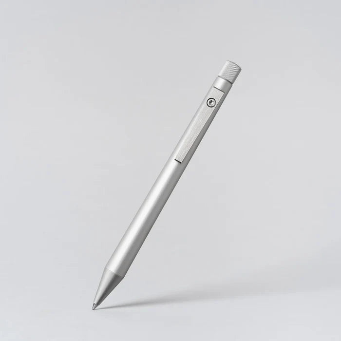 Silver pen on a light gray background
