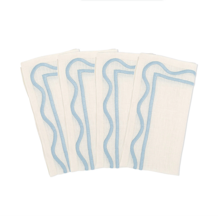 set of 4 of A folded white linen napkins with light blue geometric embroidery on the edges.