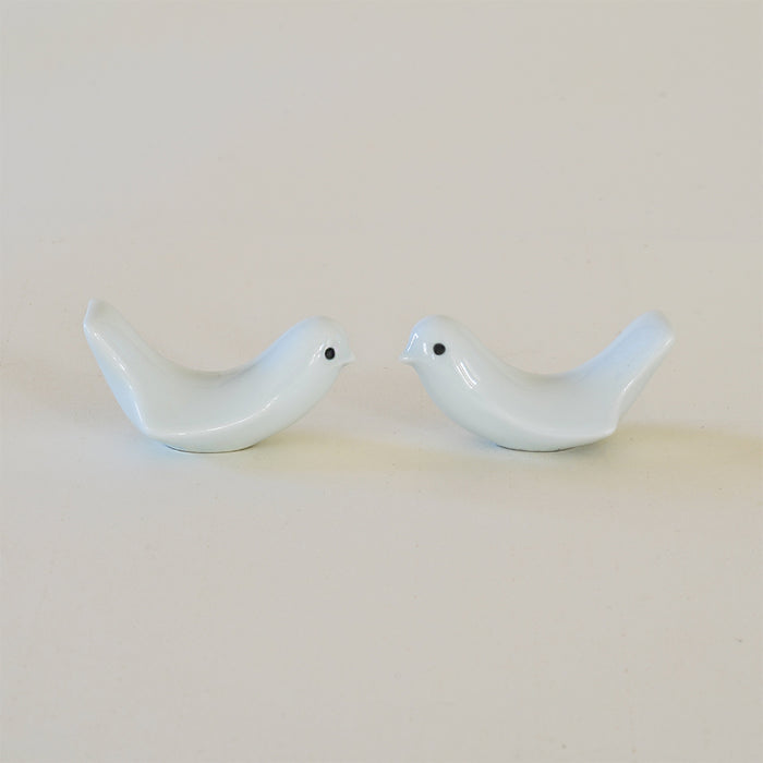 Set of two white bird-shaped ceramic chopstick rests, displayed on a clean neutral background in a minimalist tabletop product presentation.