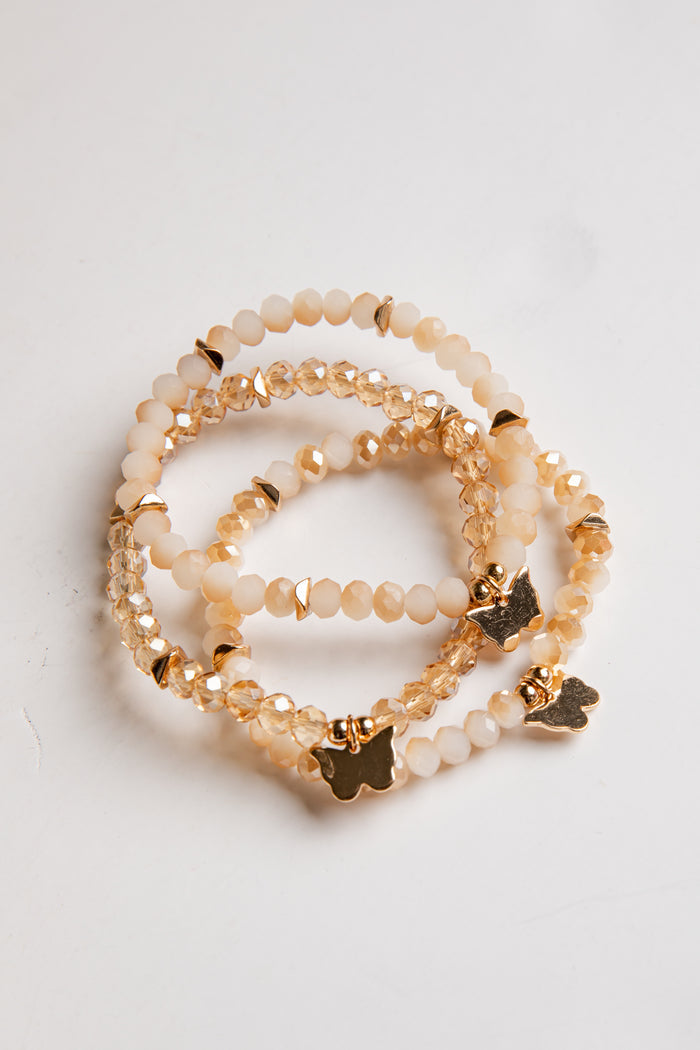 Set of beaded bracelets with gold accents on a white background