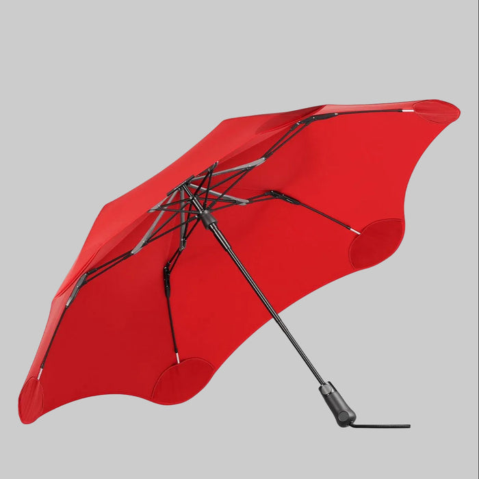 Red umbrella with black handle and ribs on a white background