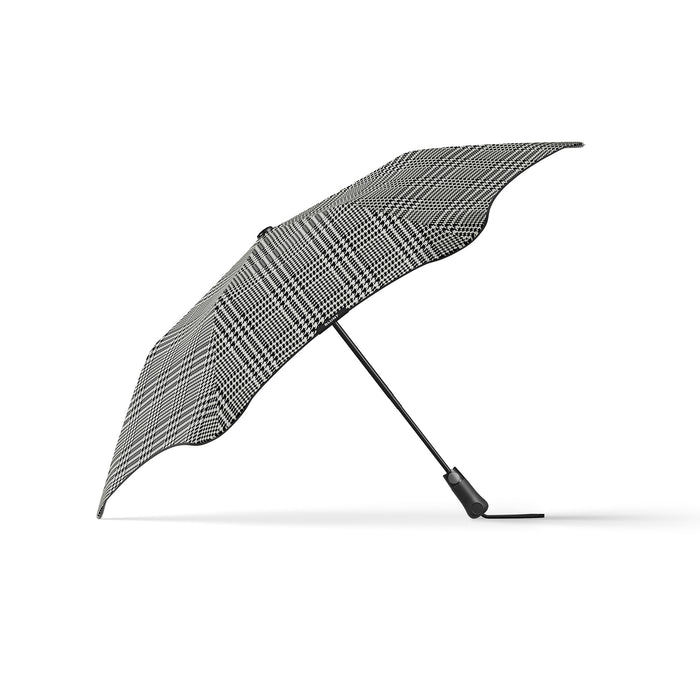 Plaid patterned umbrella on a white background