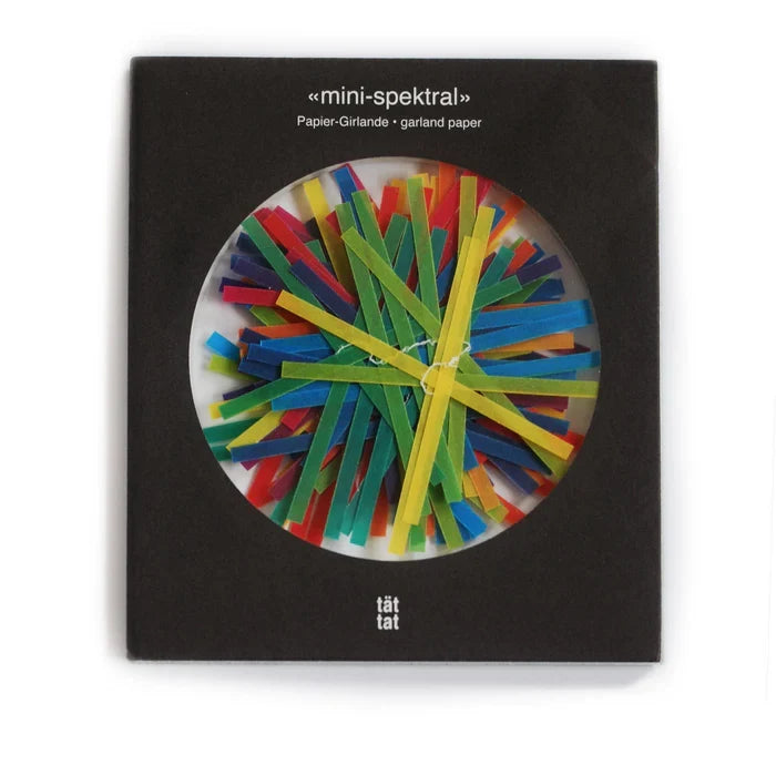 A colorful paper garland with stripes, packaged in a black round box with the product name 'mini-spektral' visible.
