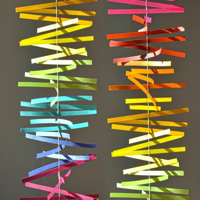 Colorful spectral paper streamers arranged in vertical rainbow gradients, abstract modern decorative design with vibrant multicolor strips.