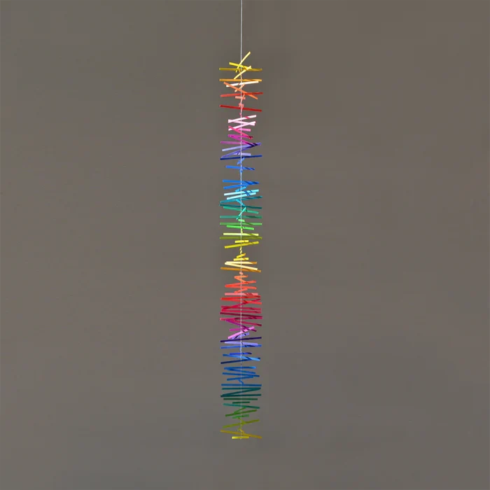 Colorful spectral paper streamers arranged in vertical rainbow gradients, abstract modern decorative design with vibrant multicolor strips.