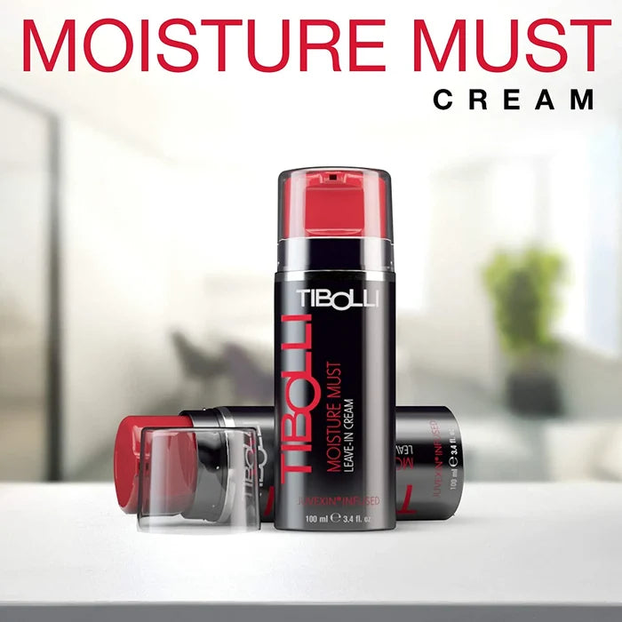Tibolli Moisture Must Cream headline above a 100 ml bottle on a white table, clear cap removed, blurred room behind