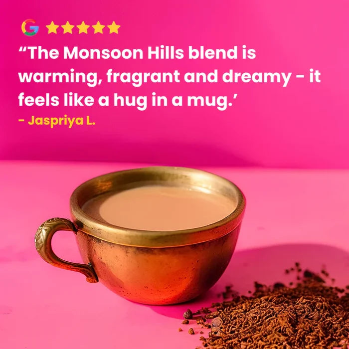Brass cup of coffee with coffee grounds on a pink background, featuring a review quote.