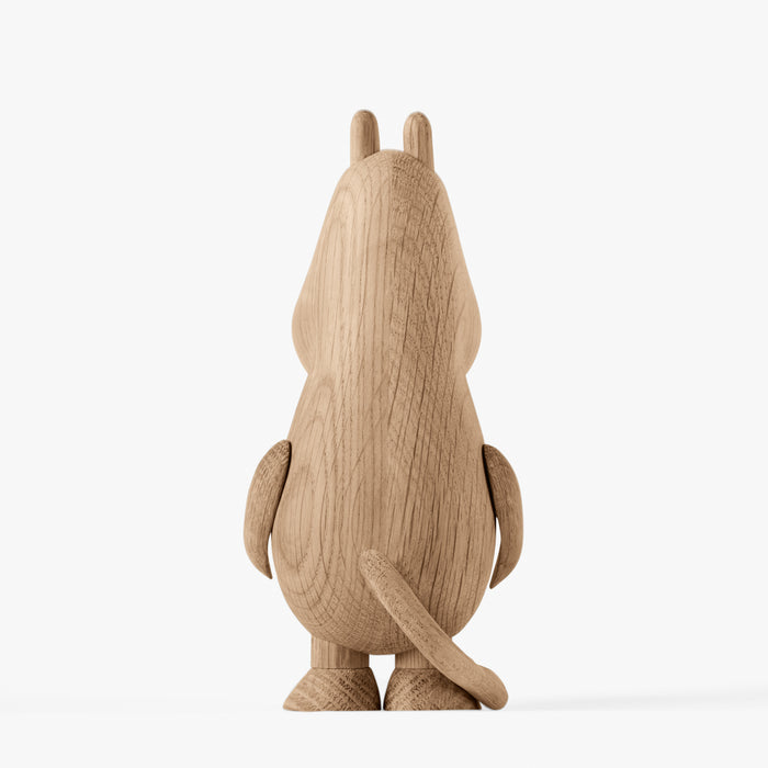 Back view of a wooden figurine of an animated cartoon character carved from light oak, featuring a tall rounded body with small ear details, smooth sculpted arms and tail, visible natural wood grain, and a matte surface on a plain white background.