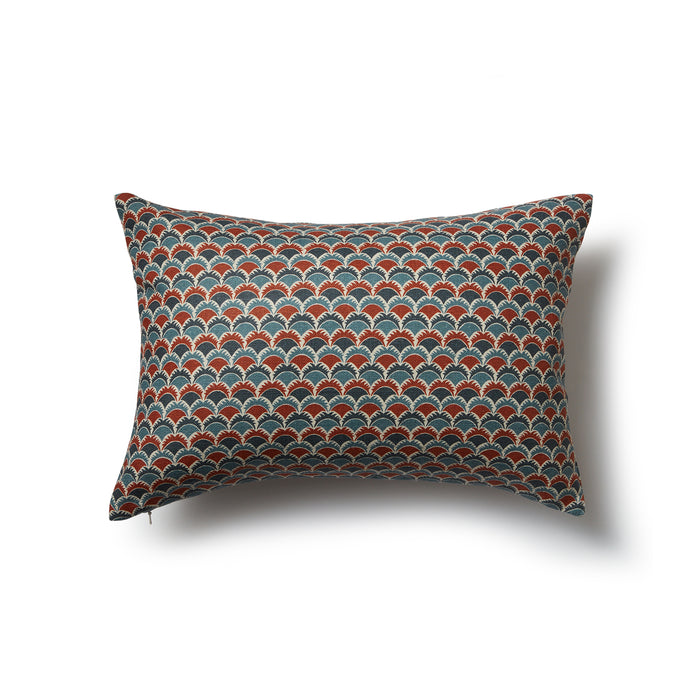 Rectangular throw pillow with a repeating Japanese-inspired scalloped pattern in shades of blue, red and cream.