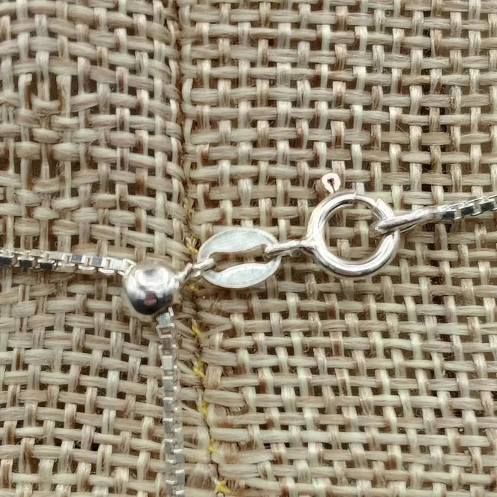 Close up of the Sterling Silver spring ring clasp and the adjustable box chain.