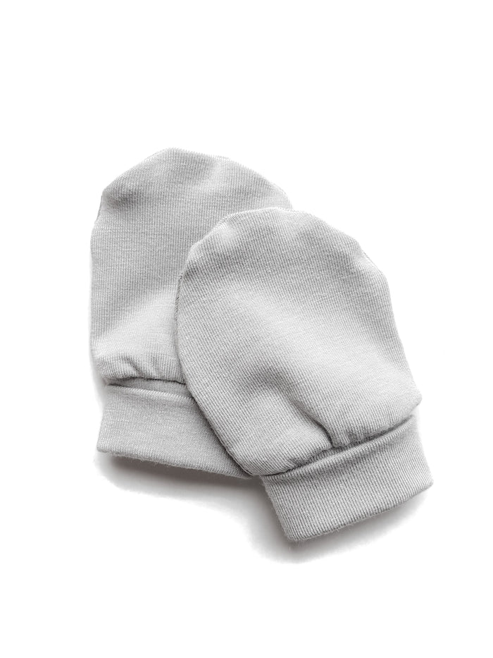 Soft and eco-friendly taupe newborn mittens, designed to protect delicate skin and prevent scratching. Ethically made in Canada for ultimate comfort and warmth