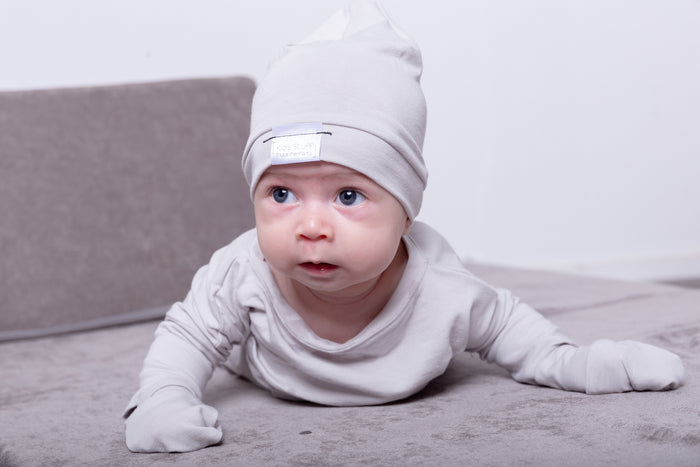 Soft and eco-friendly taupe newborn mittens, designed to protect delicate skin and prevent scratching. Ethically made in Canada for ultimate comfort and warmth