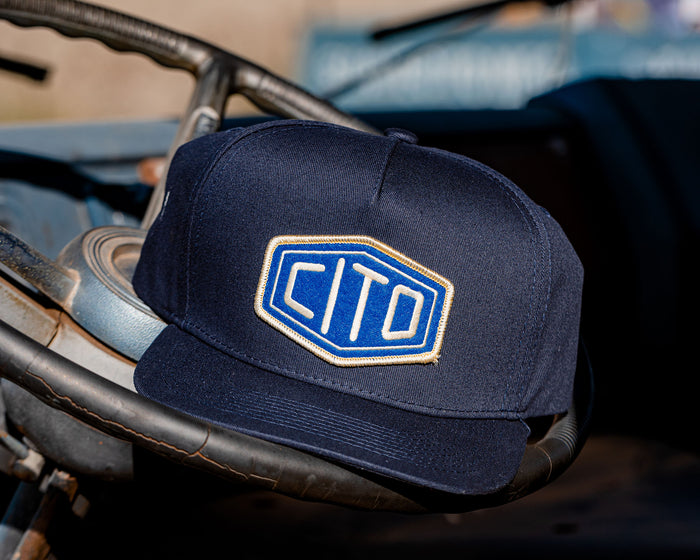 blue suavecito hat with white embroidered text and blue background "cito"