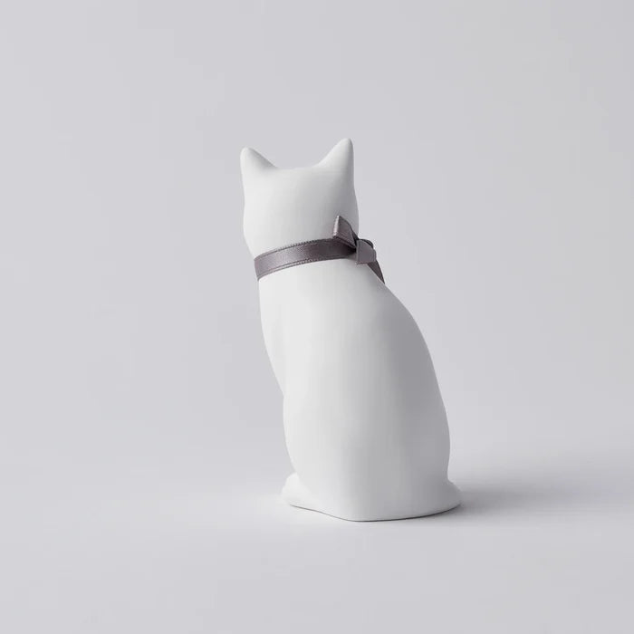 Rear view of a white cat-shaped aroma ornament with a gray ribbon bow collar, displayed on a clean white background in a minimalist home decor product presentation.