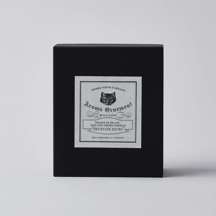Black Aroma Ornament gift box with vintage-style label and cat illustration, displayed on a clean white background in a minimalist home fragrance product presentation.