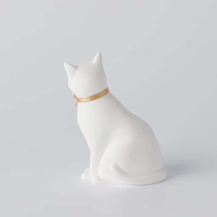 Rear view of a white cat-shaped aroma ornament with a gold ribbon collar, displayed on a clean white background in a minimalist home decor product presentation.