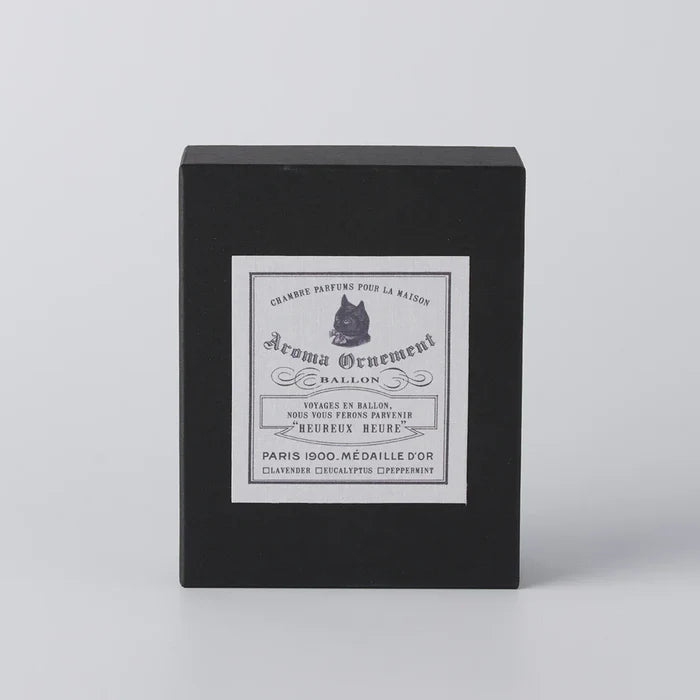 Black Aroma Ornament gift box with vintage-style label and cat illustration, displayed on a clean white background in a minimalist home fragrance product presentation.