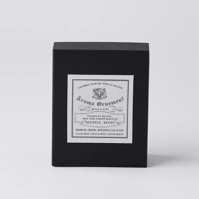 Black Aroma Ornament gift box with vintage-style label and owl illustration, displayed on a clean white background in a minimalist home fragrance product presentation.