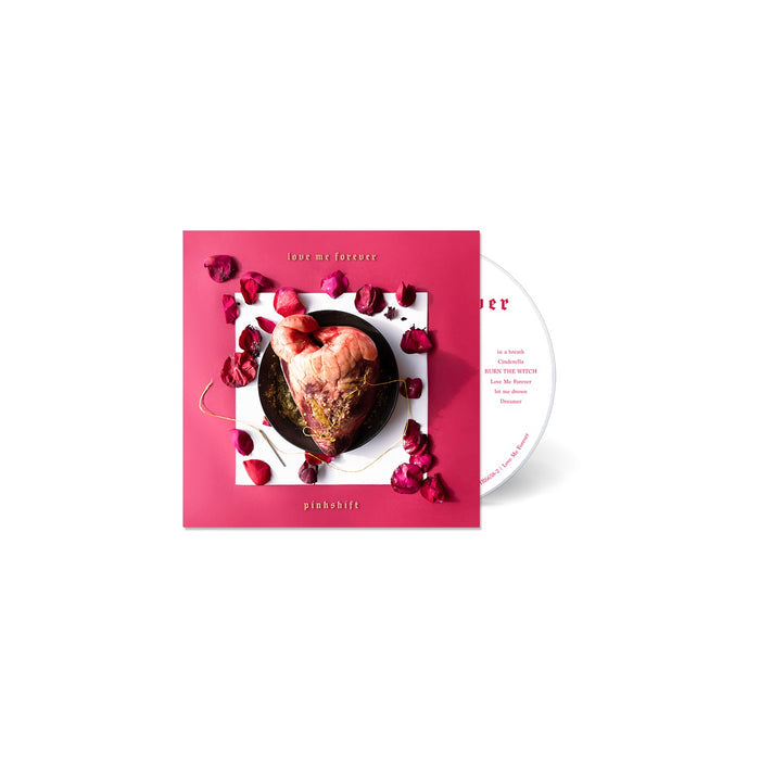 CD Album cover for Pinkshift "Love Me Foreverr" on a white background. Album cover has a square pink background. In the middle is a heart on a black plate surrounded by rose petals.