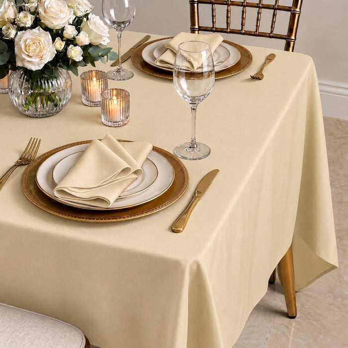 Beige wrinkle-resistant tablecloth on a beautifully set dining table.