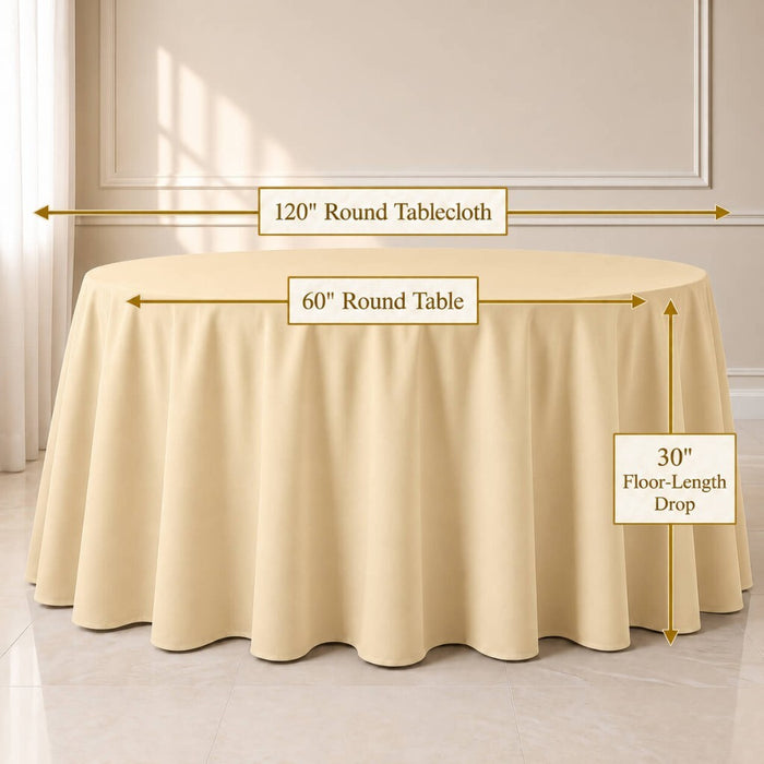 A round table covered with a light beige tablecloth in an indoor room setting, with measurement arrows and labels indicating a 120-inch round tablecloth, 60-inch round table, and 30-inch floor-length drop.