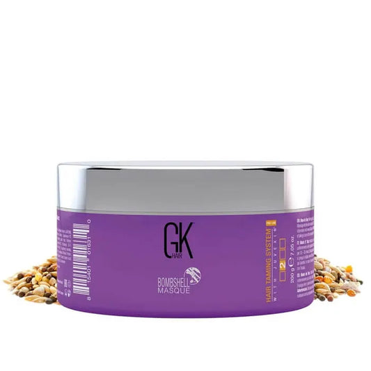 GK Hair Bombshell Masque hair taming system with Juvexin, purple 200 g tub with a silver lid, on scattered seeds and grains