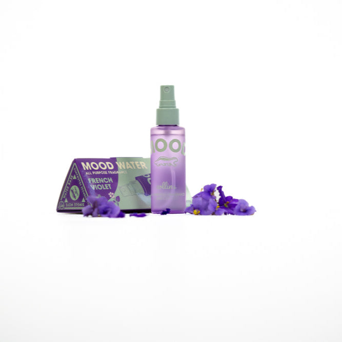 Purple spray bottle and box on a white background