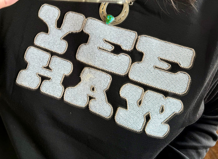 Black sweatshirt with white sequined Yee Haw lettering front detail