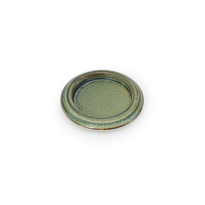A single small round ceramic dish on a white background, finished in an earthy green glaze with a slightly raised rim and subtle handmade texture.