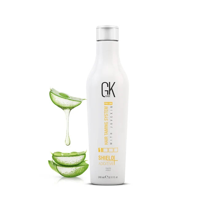 GK Hair Shield Additive+ 240 ml white bottle with a silver cap, beside aloe vera leaves and dripping gel