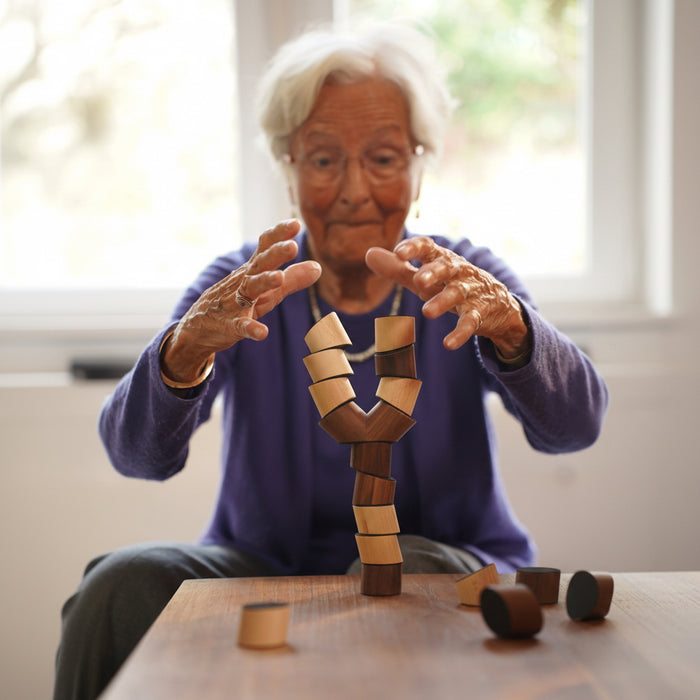 Person holding a wooden puzzle toy with a blurred background