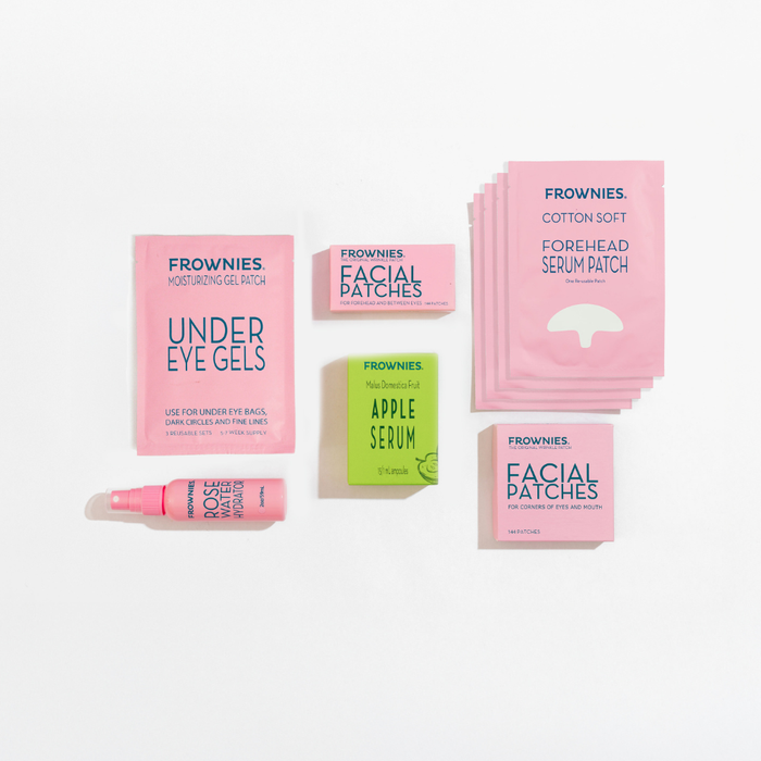 Frownies skincare products including under eye gels, facial patches, and serum patches, rose water hydrator spray, and apple stem cell serum on a white background