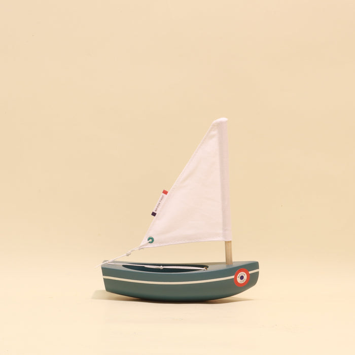 Model sailboat on a beige background