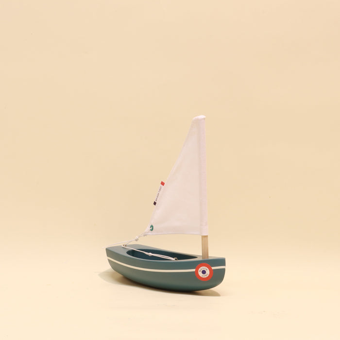 Model sailboat on a beige background