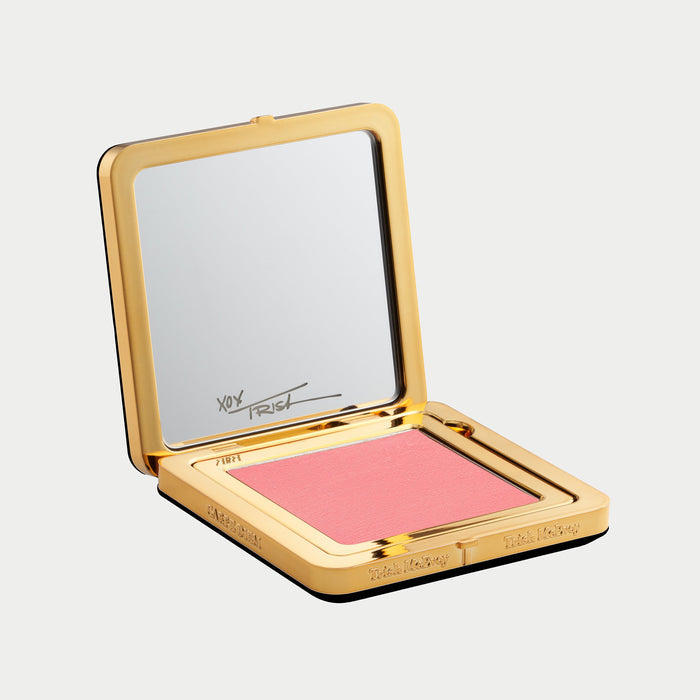 Compact so pretty blush with gold case and mirror on a light gray background