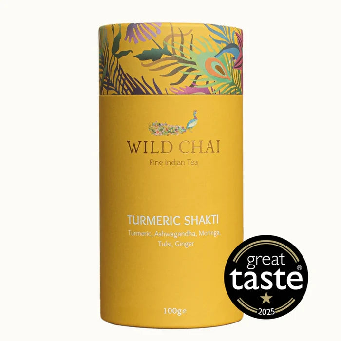 Yellow canister of Wild Chai Turmeric Shakti tea with decorative lid on a white background