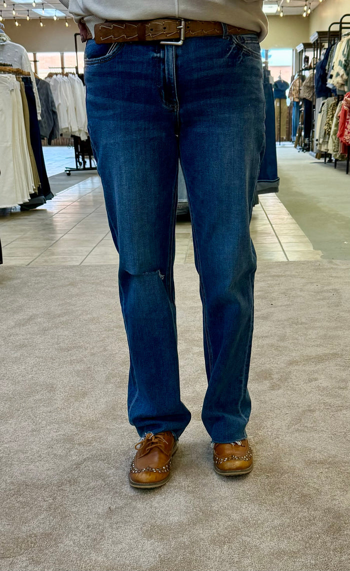 Women's straight jeans back view, dark blue wash, raw hem and belt loops