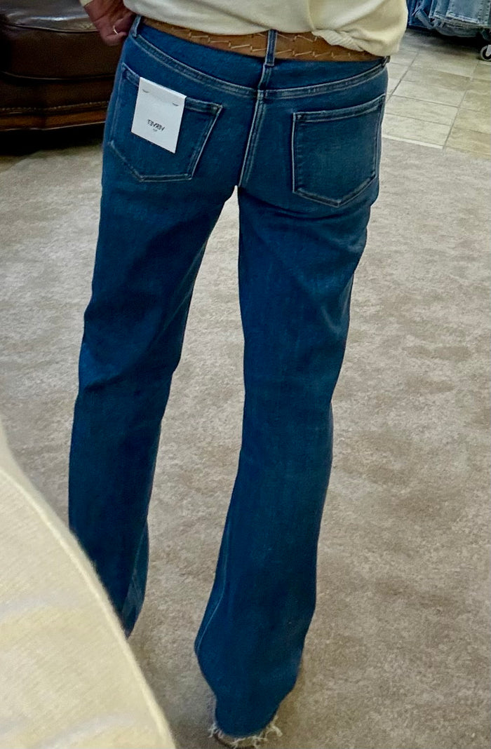 Women's straight jeans back view, dark blue wash with raw hem and back pockets